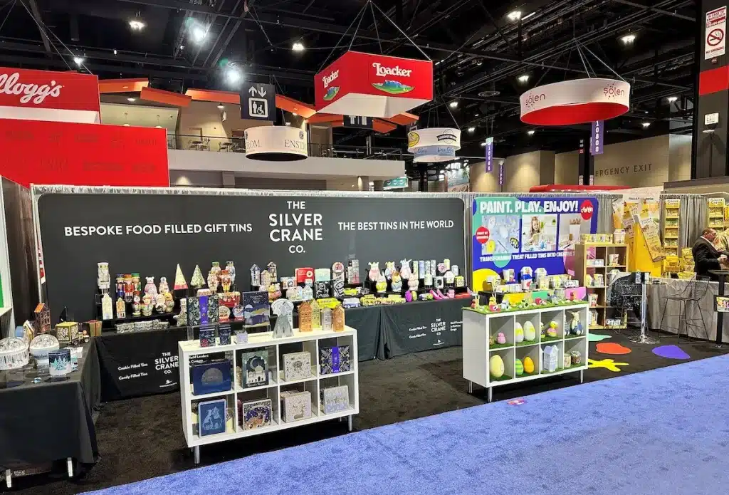 Silver Crane's stand at the Sweet & Snack Expo, featuring creative tin packaging concepts.