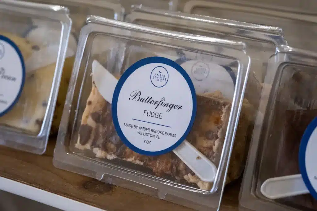 Butterfinger fudge in clear plastic container showing rigid plastic food packaging types for confectionery products.