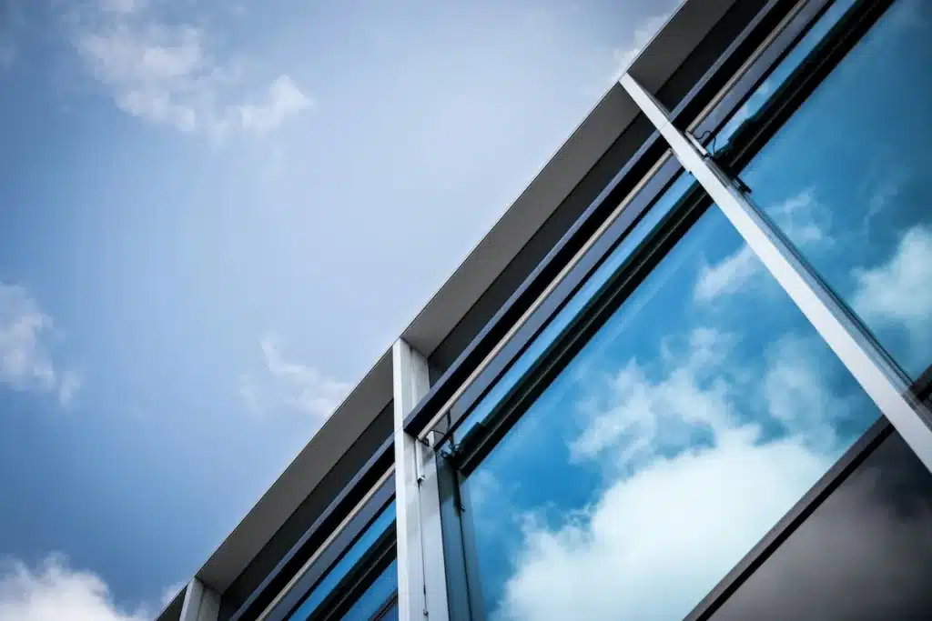 Glass window panes reflecting the blue sky, a result of a tin manufacturing process. 